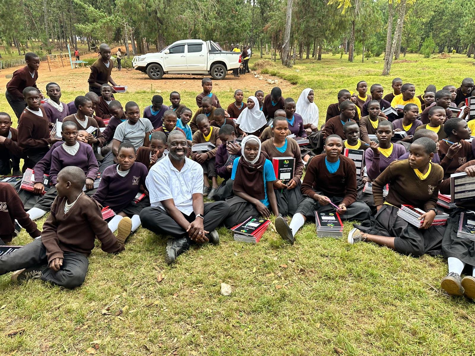 Students receiving books and learning materials through community support